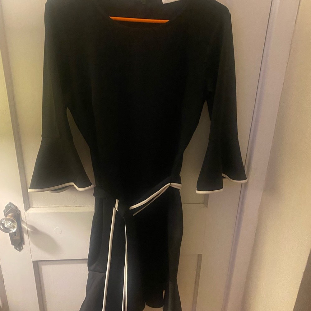 Stretchy black with white piping work or party dress.  Very forgiving material